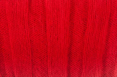 Süveter ya da atkı kumaş dokusu büyük örgü. Örülmüş forma ve kabartma desenli. Örgü ören örgüler. Yün el yapımı makine, el yapımı..