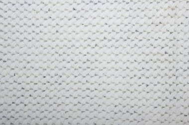 Süveter ya da atkı kumaş dokusu büyük örgü. Örülmüş forma ve kabartma desenli. Yün el yapımı makine, el yapımı.