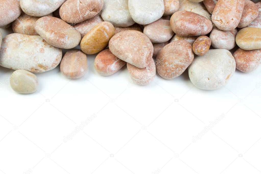 Small sea stones, isolated on white. Top view with copy space.
