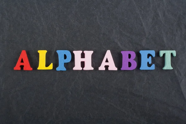 ALPHABET word on black board background composed from colorful abc alphabet block wooden letters, copy space for ad text. Learning english concept. — Stock Photo, Image