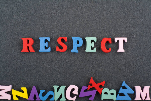 RESPECT word on black board background composed from colorful abc alphabet block wooden letters, copy space for ad text. Learning english concept