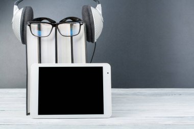 Audiobook arka arka plan üzerinde. Kitap, boş kapak, koydum kulaklık alan reklam metni kopyalayın. Uzaktan eğitim, e-öğrenme kavramı. Tablet PC