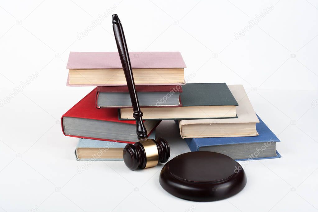 Law concept open book with wooden judges gavel on table in a courtroom or law enforcement office, white background. Copy space for text