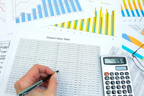 Financial printed paper charts, graphs and diagrams on the table