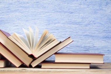 açık kitap, mavi arka plan üzerine kitaplar. Okula geri dön. Eğitici