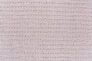 Süveter ya da atkı kumaş dokusu büyük örgü. Örülmüş forma ve kabartma desenli. Yün el yapımı makine, el yapımı..