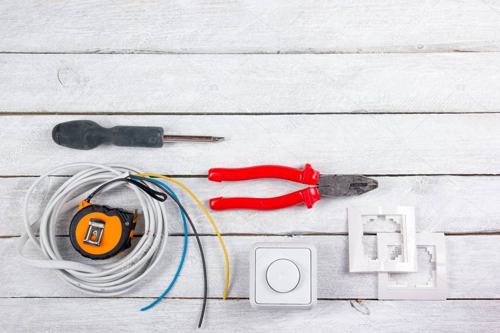 professional repairing implements for decorating and building renovation set in the wooden background, electrician. Electrical tools Top view. Copy space for text.