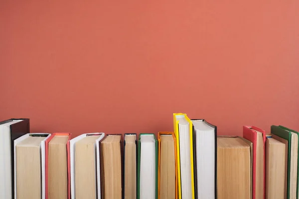 Open book, hardback colorful books on wooden table. Back to school. Copy space for text. Education business concept.