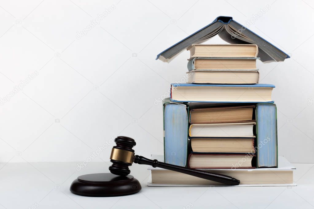 Law concept open book with wooden judges gavel on table in a courtroom or law enforcement office, white background. Copy space for text.