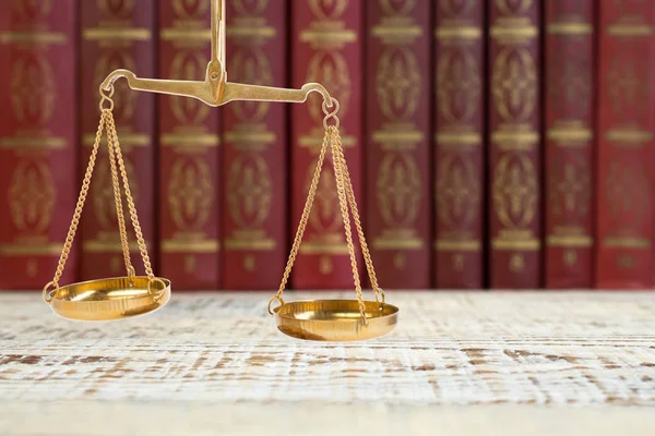 Scales of justice on law books in library of law firm. legal education concept. — Stock Photo, Image