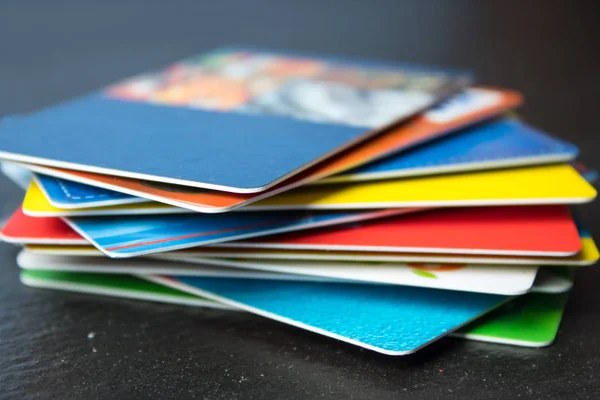 Stack of bank cards on a black background.