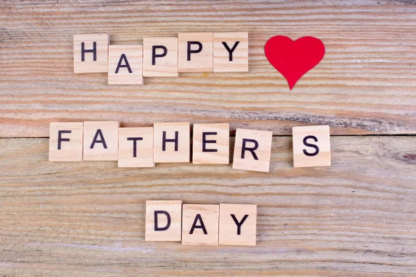 Happy Fathers day on wooden background. symbols of love father