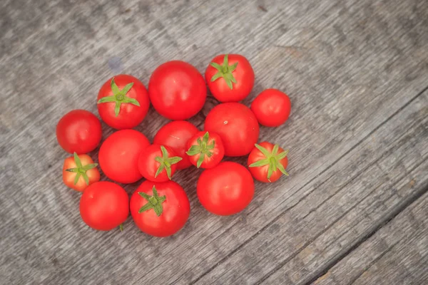 Wiśniowe pomidory na tle drewnianych. Jesiennych zbiorów. — Zdjęcie stockowe