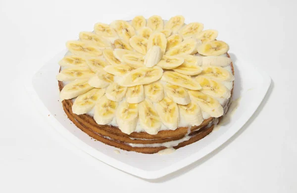 Banana cake biscuit on a white background. Sweet cake with condensed milk sauce. Bakery products