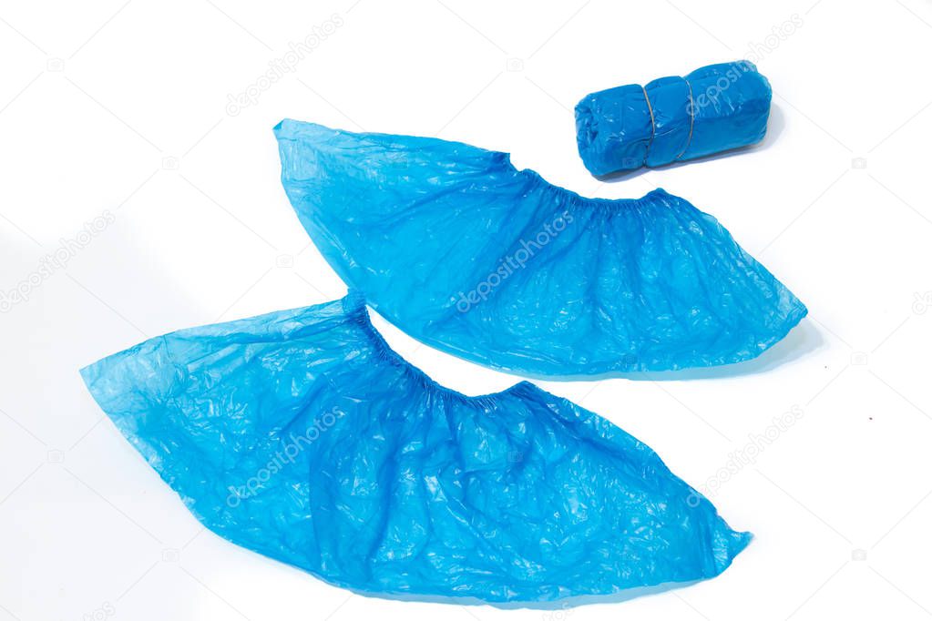 Blue shoe covers on a white background. Clean building does not carry dirt from shoes indoors