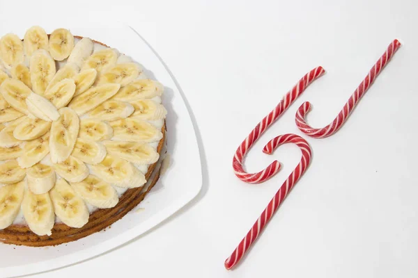 Banana cake biscuit on a white background. Sweet cake with condensed milk sauce. Bakery products