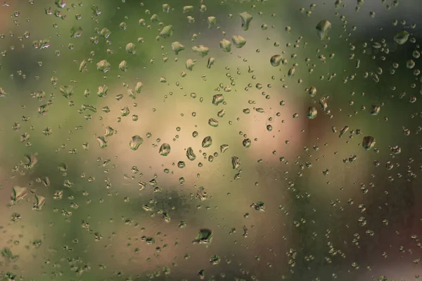 Drops of water on the glass. Background of water drops flowing down the glass. Texture of water droplets. Natural water, wet drops