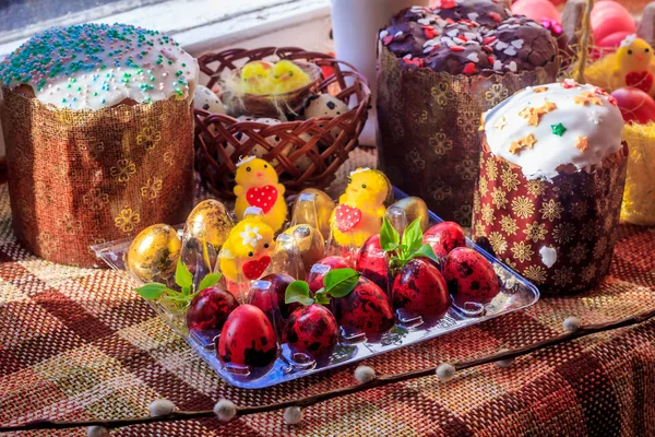 Postcard Happy Easter. Congratulations on a religious holiday. Orthodox holiday. Painted Easter eggs and traditional sugar-topped Easter cakes