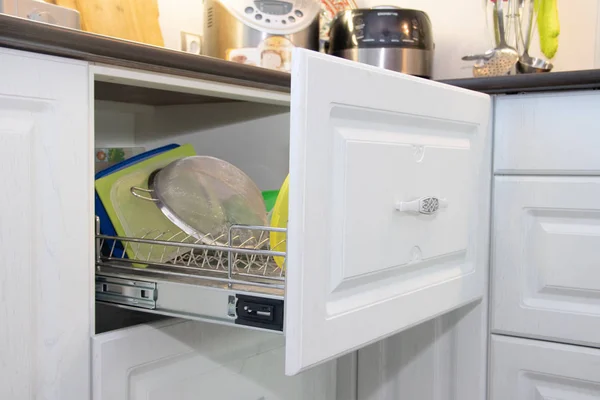 White kitchen. Wooden kitchen. Modern furniture and kitchen interior. Kitchen to individual sizes. White cabinets, gray handles, drawers, cabinet doors. Russia, Leningrad region, Alapur village January 12 2019