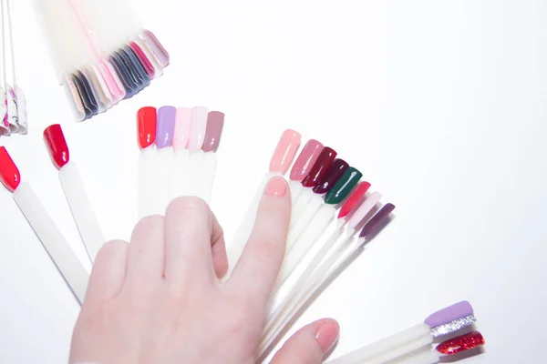 Cuidado de uñas y concepto de manicura. Paleta de esmalte de uñas multicolor para elegir las uñas del cliente. Mujer en el salón de belleza. Copyspace para texto —  Fotos de Stock