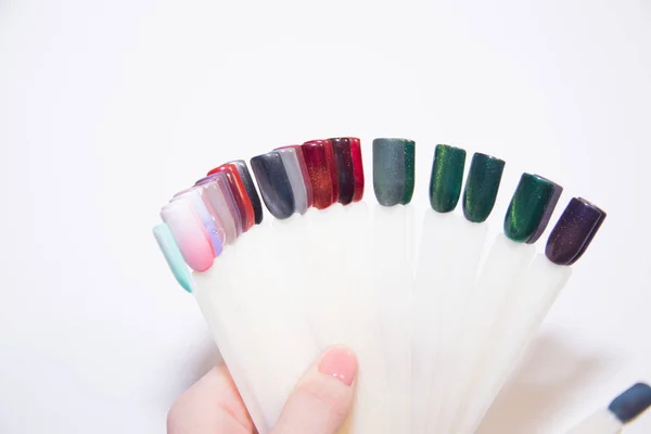 Nail Care And Manicure concept. Multicolor Nail Polish palette for Client\'s Nails choise. Woman In Beauty Salon. Copyspace for text