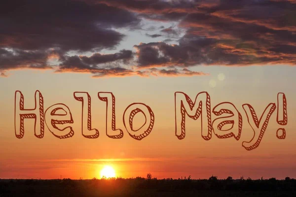 Banner Hello May. Greeting the new month. Hi spring. The text in the picture of the sunset. Evening sunset Sunset.