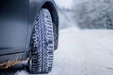 Wheel with spikes on winter road, protected tire