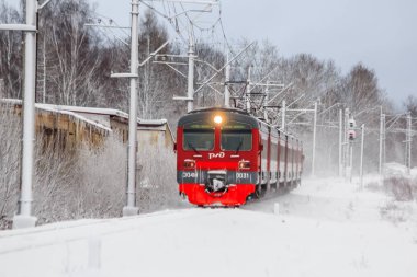 Kış ormanı boyunca raylı kırmızı Rus treni, Rusya, Leningrad bölgesi, Gatchina bölgesi, 26 Aralık 2018