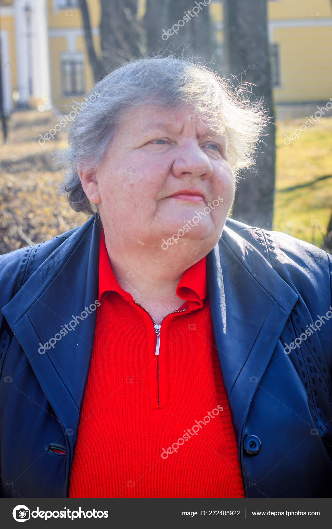 Elderly Woman On A Bench In The City Grandmother In A Red Sweater