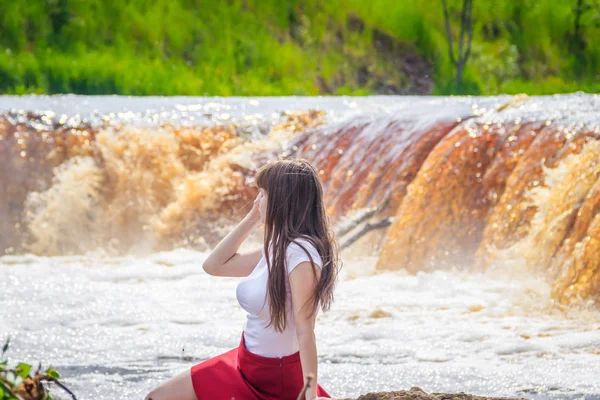 portrait of young beautiful woman at the waterfall, Russia