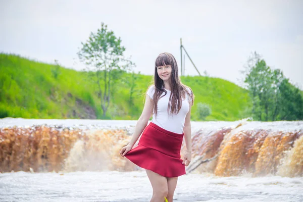 portrait of young beautiful woman at the waterfall, Russia