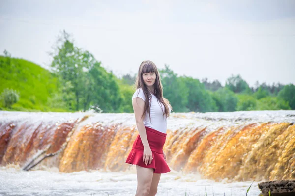 portrait of young beautiful woman at the waterfall, Russia