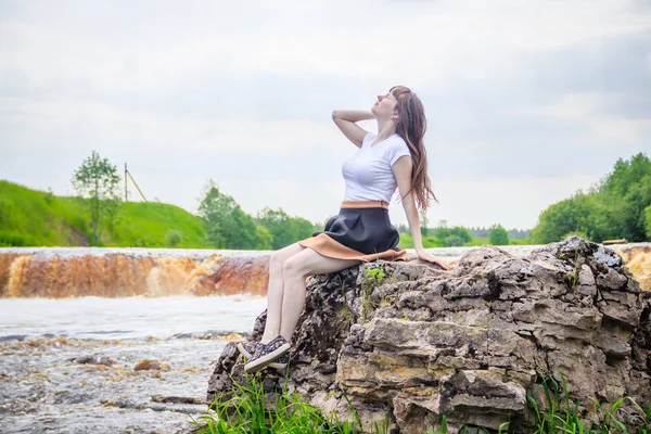 portrait of young beautiful woman at the waterfall, Russia