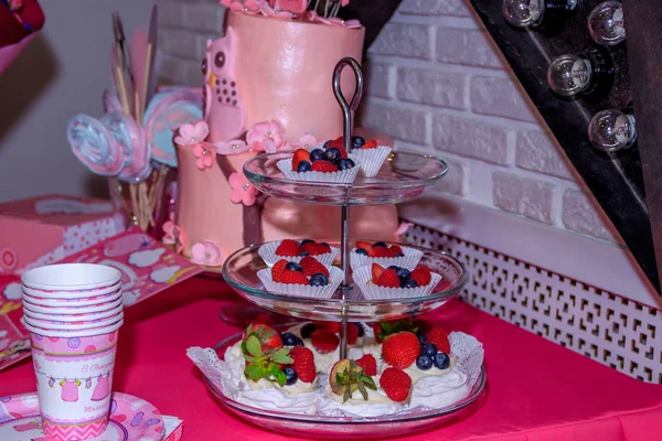 子供のピンクの誕生日ケーキ。お祝いのテーブルの装飾。お 祝い。子供の休日。ベリーとお菓子. — ストック写真