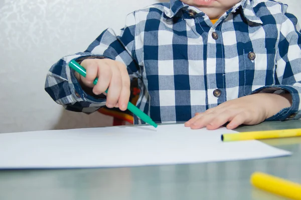 little boy drawing felt-tip pens on paper