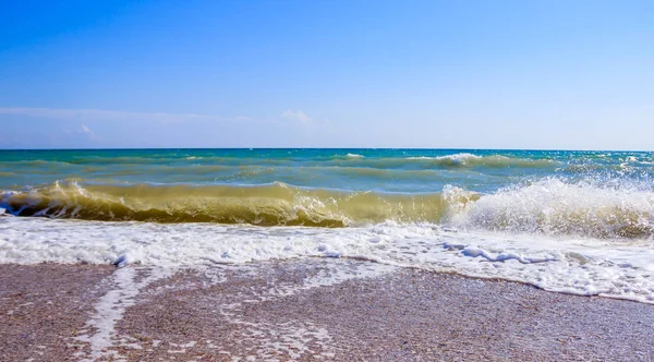 Sea waves. Sea of Crimea. High waves in clear weather. Sunny day at sea. Background blue sea waves. Sand beach. Clean beach.