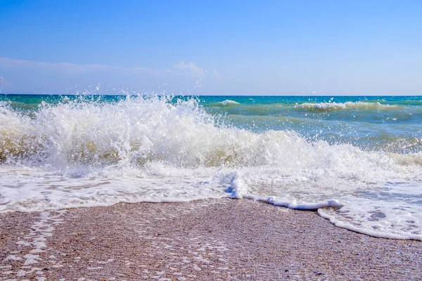 Sea waves. Sea of Crimea. High waves in clear weather. Sunny day at sea. Background blue sea waves. Sand beach. Clean beach.