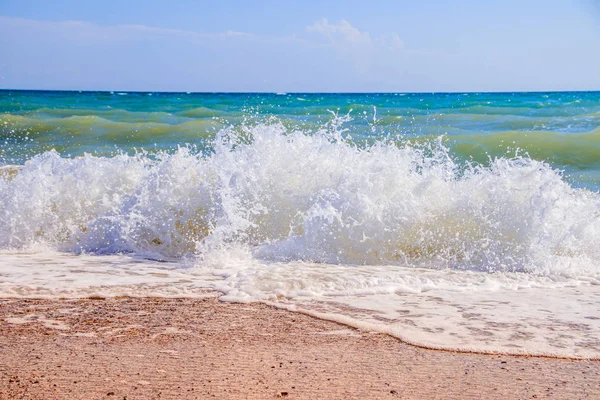 Sea waves. Sea of Crimea. High waves in clear weather. Sunny day at sea. Background blue sea waves. Sand beach. Clean beach.