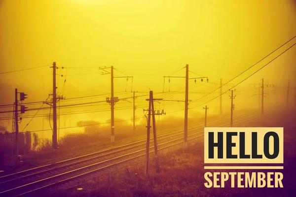 Hello September banner. New month. Greeting card. Golden autumn. The text in the photo. . Fog. Gloomy weather