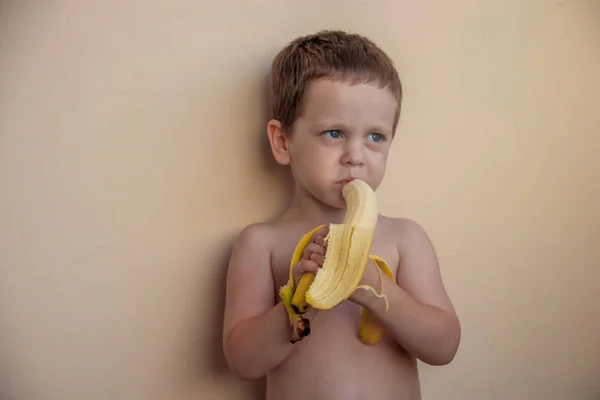 Cute Little Boy Eating Banana Pastel Background — Stock Photo, Image