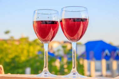 bulanık arka planda kırmızı şarap ile iki bardak yakın 