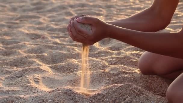 Boy Pouring Sand Hands Beach — Stockvideo
