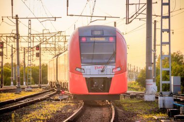 Russia, Lyuban - August 15, 2019: Summer railway of Russia, iron path, sunset background  clipart