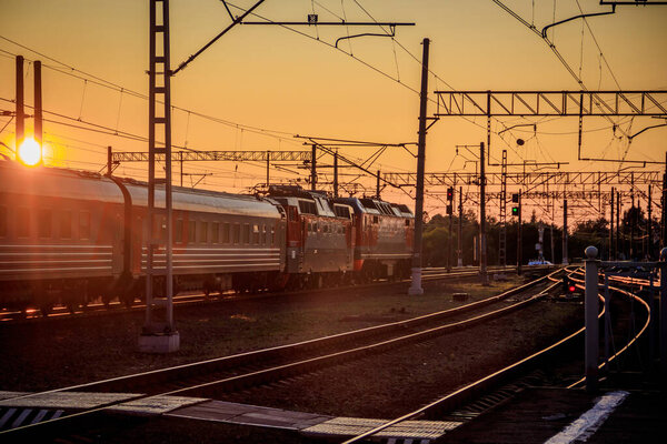 Russia, Lyuban - August 15, 2019: Summer railway of Russia, iron path, sunset background 
