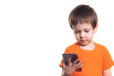 A small boy with a phone on a white background. Boys phone. The children of today . Connection with the child. Benefits and harms of phones . Smartphone for a small child clipart