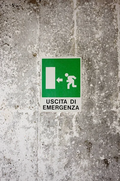 Green Emergency Exit Sign on a wall with italian words