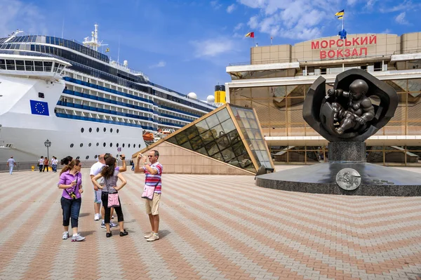 Odessa, Ukrayna - 2 Haziran 2010: Odessa limanında seyir gemisi. Deniz istasyonunun arka planında yabancı turistlerin fotoğrafları çekiliyor..