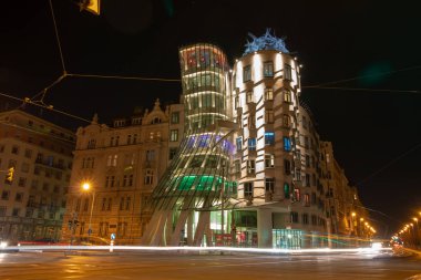 Dancing house in night with traffic lights clipart