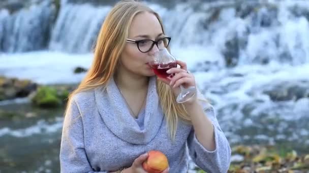 Dziewczyna, degustacja wina i jedzenia jabłko — Wideo stockowe