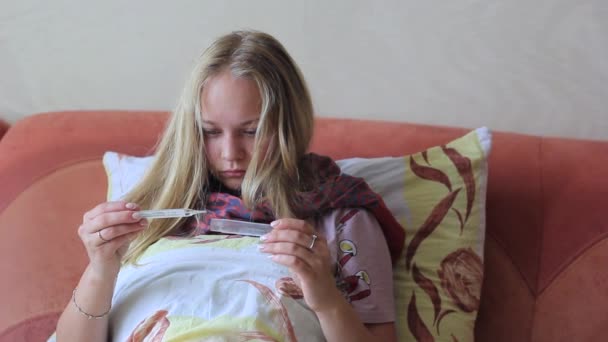 Het meisje is ziek met een grip. Maatregelen lichaamstemperatuur met thermometer — Stockvideo